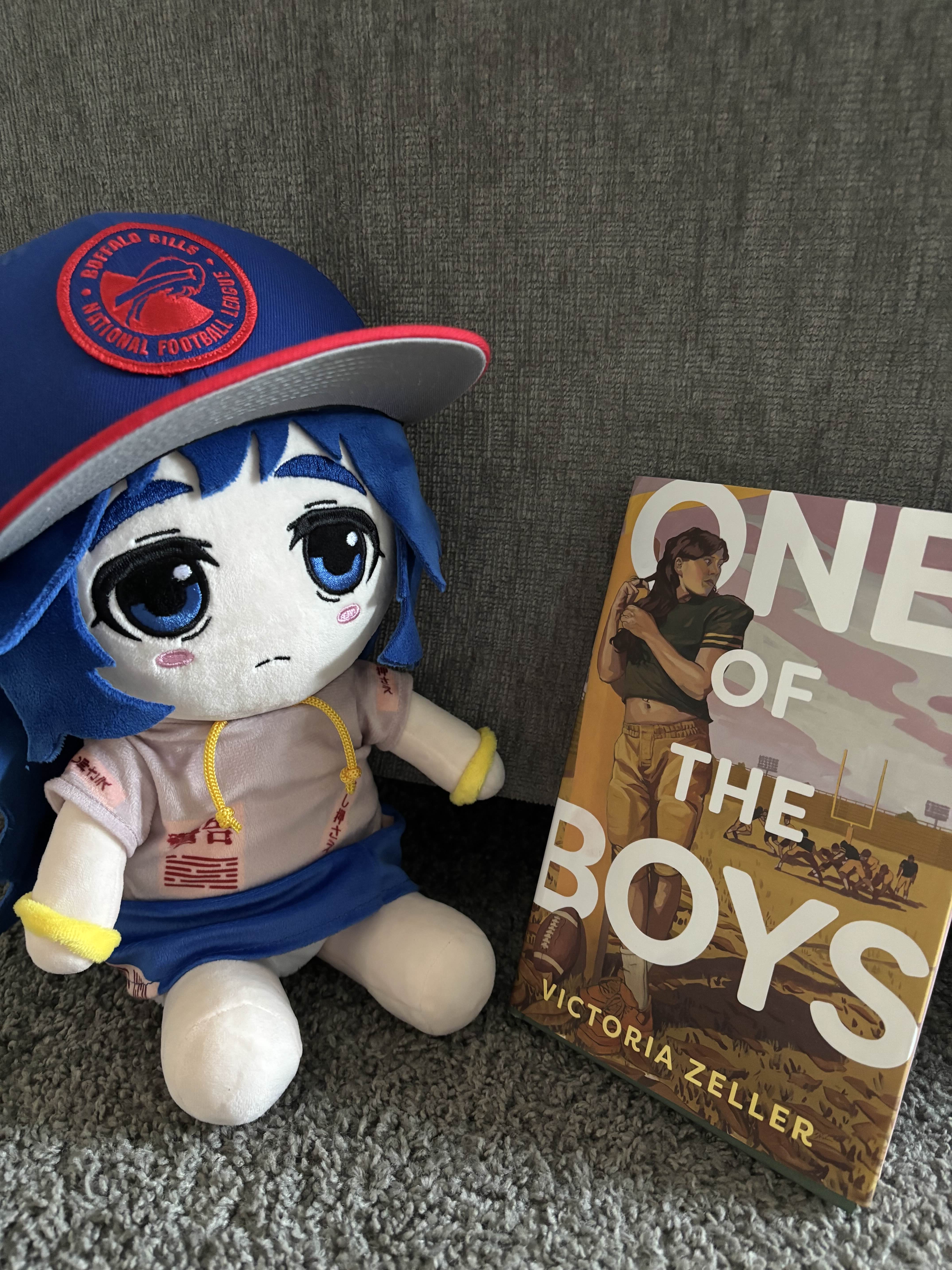 Bills Shion sitting next to a hardcover copy of One of the Boys